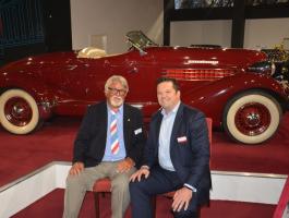 Micheal Penn with museum CEO Chris Haynes in front of the 1936 Auburn 852 Supercharged Boat Tail Speedster